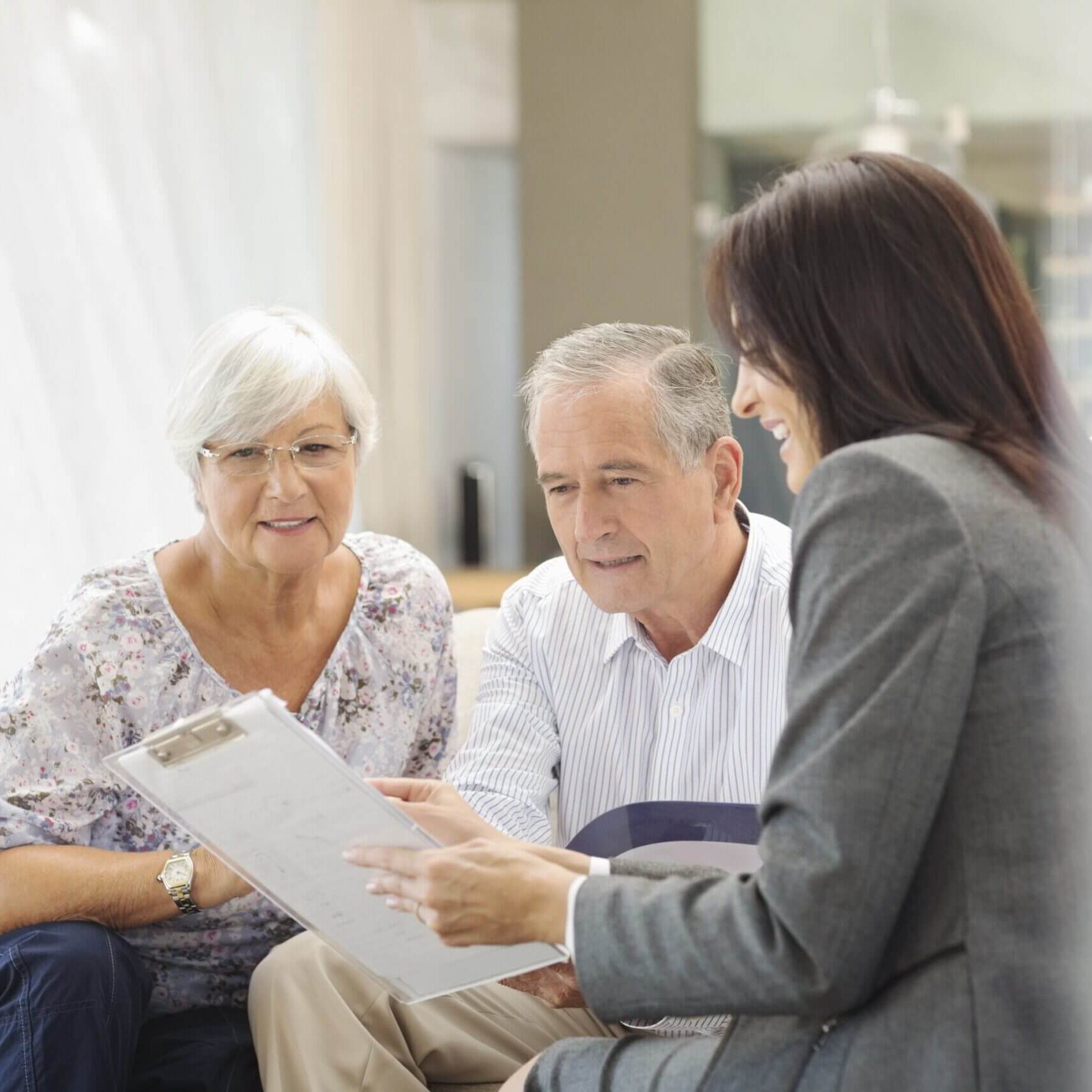 Elderly couple consulting with a professional advisor.